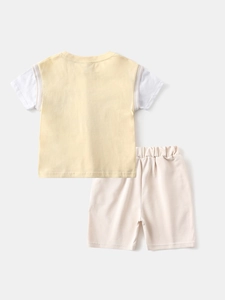 Boys summer two-piece casual set featuring a yellow patchwork t-shirt and light beige shorts