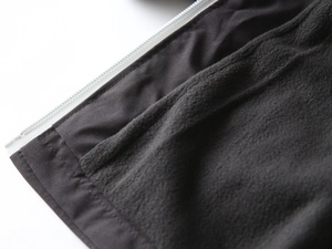 Macro detail of the warm fleece lining and sturdy zipper of this boys' outdoor jacket