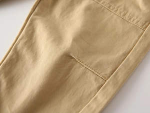 Macro shot of khaki cotton twill fabric with reinforced double stitching detail