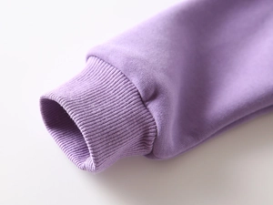 Close-up of tight ribbed cuffs on thick purple fleece sweatshirt for boys