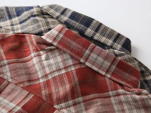 Close-up of the cotton plaid shirts showing the collar stitching and durable fabric texture