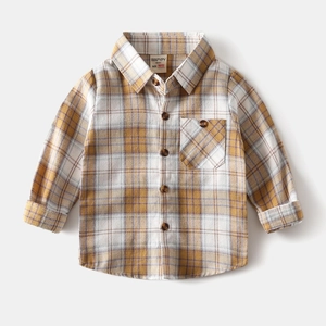 Close-up of yellow plaid cotton shirt collar showing buttoned chest pocket and soft texture