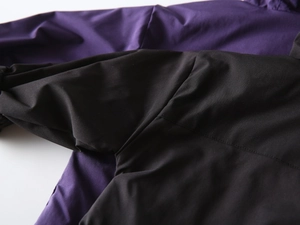 Close-up of high-quality flat-fell seams on durable windproof outdoor jackets