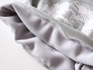 Detail of boys' warm fleece lining and ribbed cuff on a gray printed sweatshirt