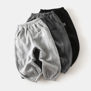 Close-up of boys' thick fleece sports pants in grey and black with GOODTHING print