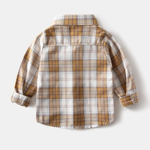 Macro detail of boys' yellow plaid long-sleeve shirt showing soft brushed fabric texture