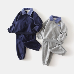 Detail of boys' navy and grey two-piece tracksuit sets with plaid polo collar accents