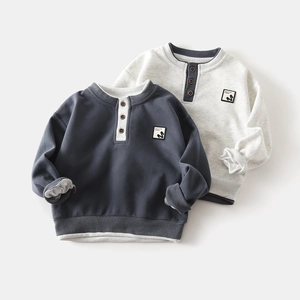 Close-up of children's cotton sweatshirts with buttoned Henley necks and ribbed details