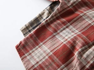 Close-up of red and blue checkered cotton fabric showing high-quality textile texture