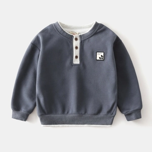 Detail of grey-blue children's sweatshirt with white ribbed V-neck and button closure