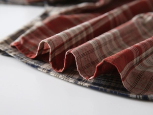 Close-up detail of high-quality red and blue plaid fabric texture for children's shirts