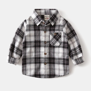 Close-up of boys plaid shirt with flannel texture, classic buttons and chest pocket