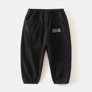 Close-up of black fleece-lined boys' joggers with elastic waist and white lettering