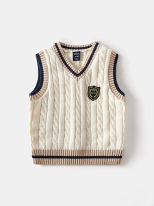 Classic cream V-neck cable knit vest for boys with striped ribbed edges and badge detail
