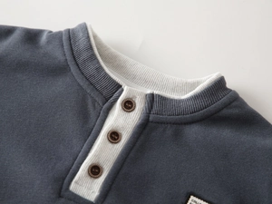 Detailed view of kids' V-neck sweatshirt with rib-knit collar and vintage buttons