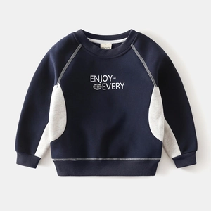 Detail of color-block boys sweatshirt with white stitching and globe graphic print