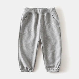 Detail of grey children's cotton sweatpants with elastic waistband and ribbed cuffs