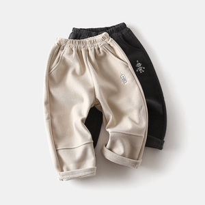 Close-up of children's corduroy pants with elastic waist and robot embroidery
