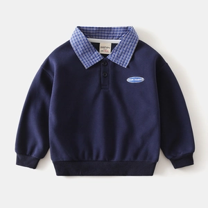 Detail of navy blue kids sweatshirt featuring checkered collar and GAME CHANGER embroidery