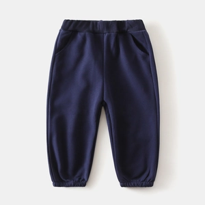 Detail of navy blue kids' cotton trousers with elastic waistband and ribbed cuffs