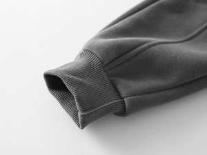 Vue macro des poignets côtelés serrés sur un pantalon d'hiver épais gris foncé pour enfant