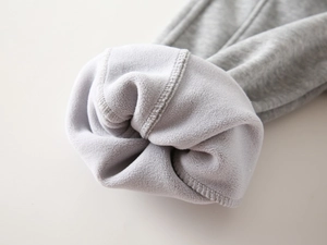 Detail shot of boys' thick fleece lining and grey knit fabric for winter warm joggers