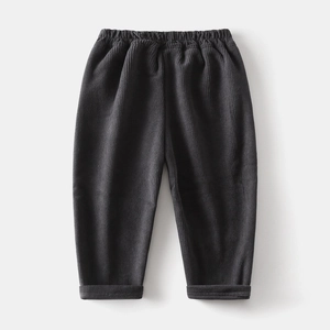 Detailed view of dark grey corduroy trousers for kids with elastic waistband and warm fabric