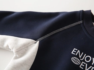 Detail of navy and grey colorblock sweatshirt with ribbed neckline and fine stitching
