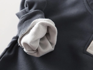 Detailed macro view of dark grey sweatshirt ribbed cuffs with soft plush lining material