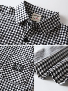 Classic black and white gingham boys' shirt featuring a chest pocket and fashion patch