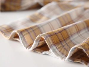 Close-up of soft brushed yellow plaid fabric texture for autumn kids shirts