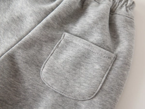 Detail shot of winter boys gray joggers showing elastic waistband and stitching on the pocket
