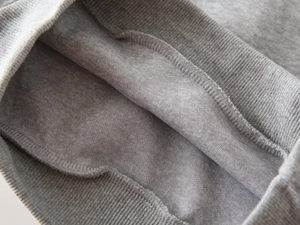 Detailed view of grey boy's sweatshirt with ribbed cuffs and warm fleece lining