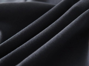 Close-up of premium dark grey knit fabric texture for children's V-neck sweatshirt