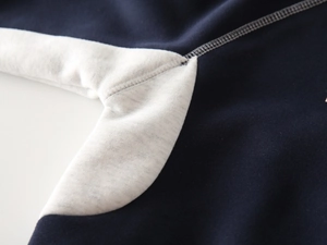 Detailed view of color-block stitching and fabric texture on a boys' warm thick sweatshirt