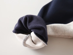 Detail of boys hoodie sleeve showing thick fleece lining and durable edge stitching