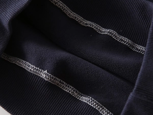 Detailed macro view of navy blue sweatshirt showing warm fleece lining and ribbed cuffs