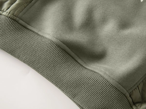 Detail of ribbed hem on army green fleece sweatshirt for boys with premium stitching