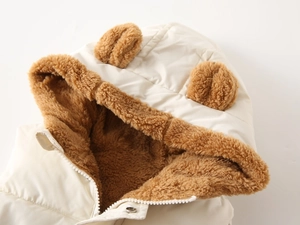 Detail of baby hooded vest showing warm brown sherpa lining and cute bear ear design
