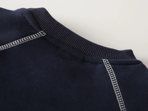 Close-up of boys thick sweatshirt showing ribbed crew neck and white contrast stitching