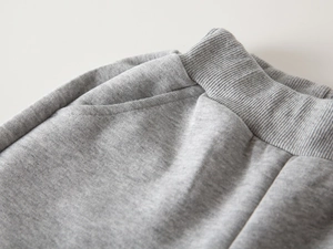 Détail du pantalon de jogging gris pour enfant avec taille élastique côtelée et poche