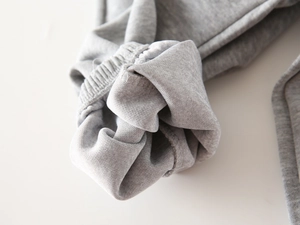 Detailed macro view of elastic ribbed cuffs on grey knit cotton boys leisure set