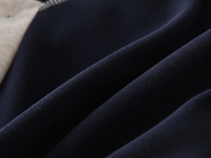 Detailed close-up of navy and grey patchwork fabric showing thick fleece texture and stitching