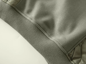 Detail of olive green ribbed cuff and patchwork stitching on toddler winter hoodie