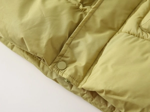 Detail of children's thick padded coat hem with zipper and snap button closure