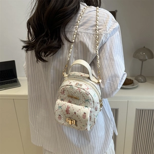 Mini white backpack with pink floral bear patterns and golden chain strap for women