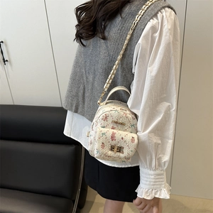White textured mini backpack with pink rabbit floral print and gold chain strap