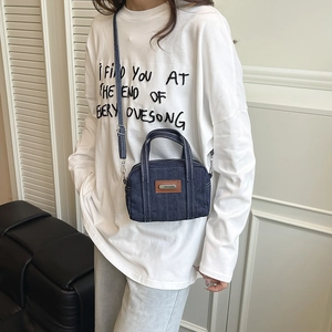 Deep blue denim mini pillow bag with leather plaque and adjustable crossbody strap
