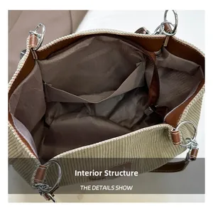 Internal structure of large corduroy tote showing main pocket and zipper compartments
