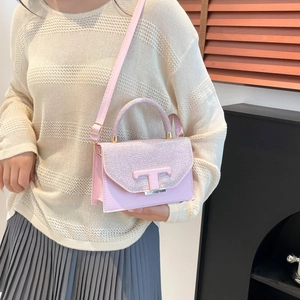Pink glitter patchwork crossbody bag with metallic T-shaped clasp and leather strap